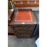 A mahogany and red leather topped filing cabinet