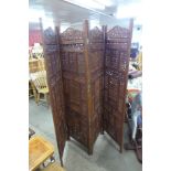 An oriental carved hardwood four panel screen