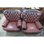 A pair of red button back leather armchairs