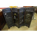 An early 20th Century Japanese carved ebonised and mother of pearl inlaid folding table screen