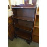A mahogany waterfall front open bookcase