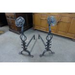 A pair of Arts and Crafts cast steel andirons