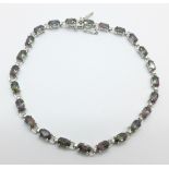 A 9ct white gold and mystic topaz tennis bracelet, 4.5g