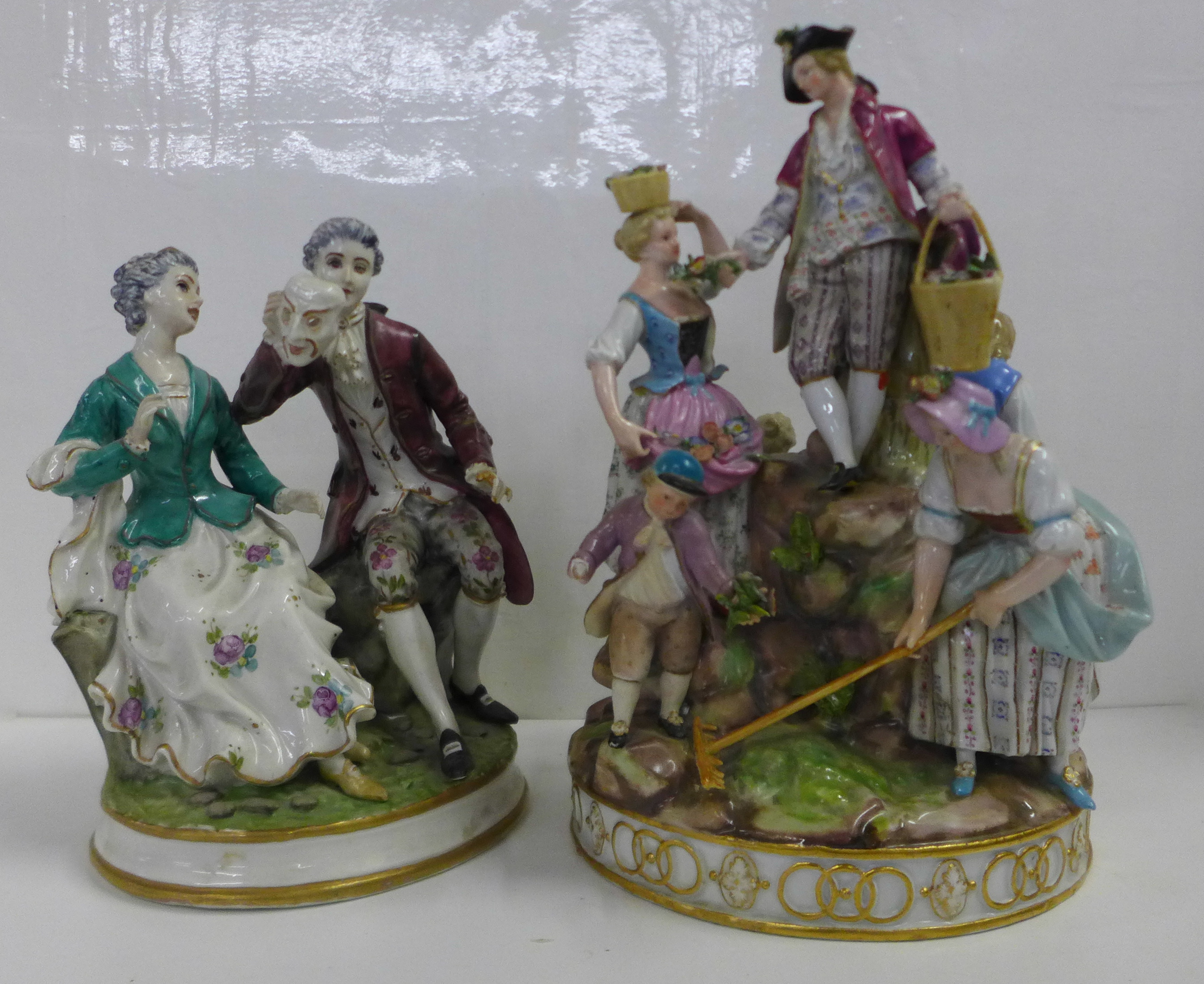 Two German porcelain figure groups; couple seated, with theatrical mask, and Meissen Gardening