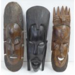 Three carved African face masks