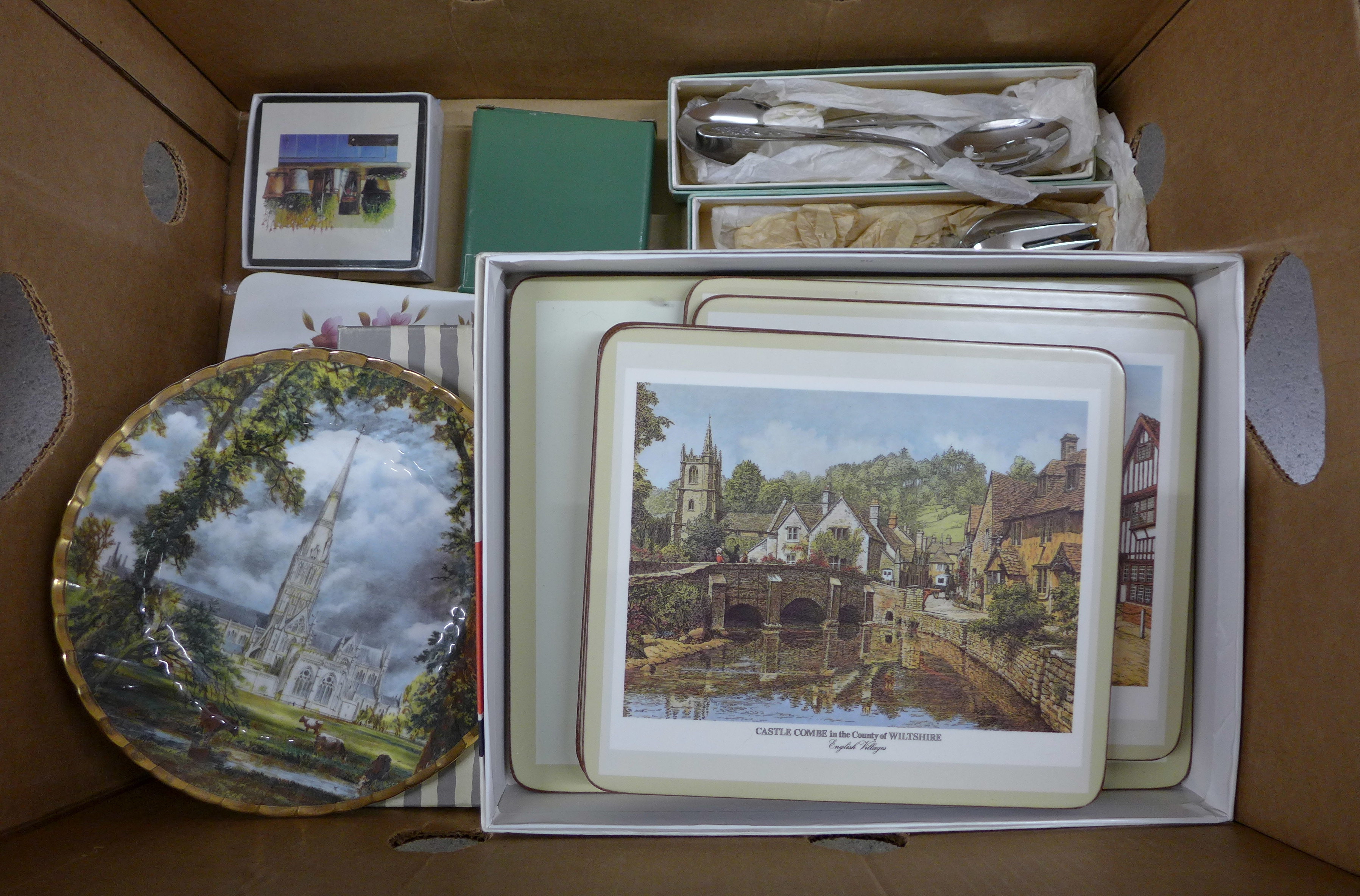 A collection of items including coasters, cutlery sets, salad servers, a plate, place mats, etc. **