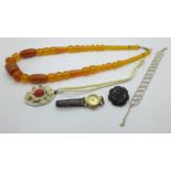 An amber bead necklace, a Liberty coin watch, a paste set bracelet, a necklace and brooch