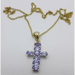 A silver gilt tanzanite cross pendant on chain