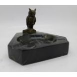 A marble ashtray with a bronze figure of an owl