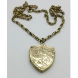 A late Victorian plated shield shaped locket with chain, locket a/f