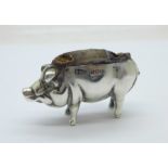 A novelty hallmarked silver pig pin cushion, Birmingham 1907, length 51mm, cushion requires repair