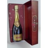 A bottle of Krug champagne in a presentation box, box a/f (damp stained)