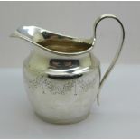 A silver cream jug, London 1911, 115g