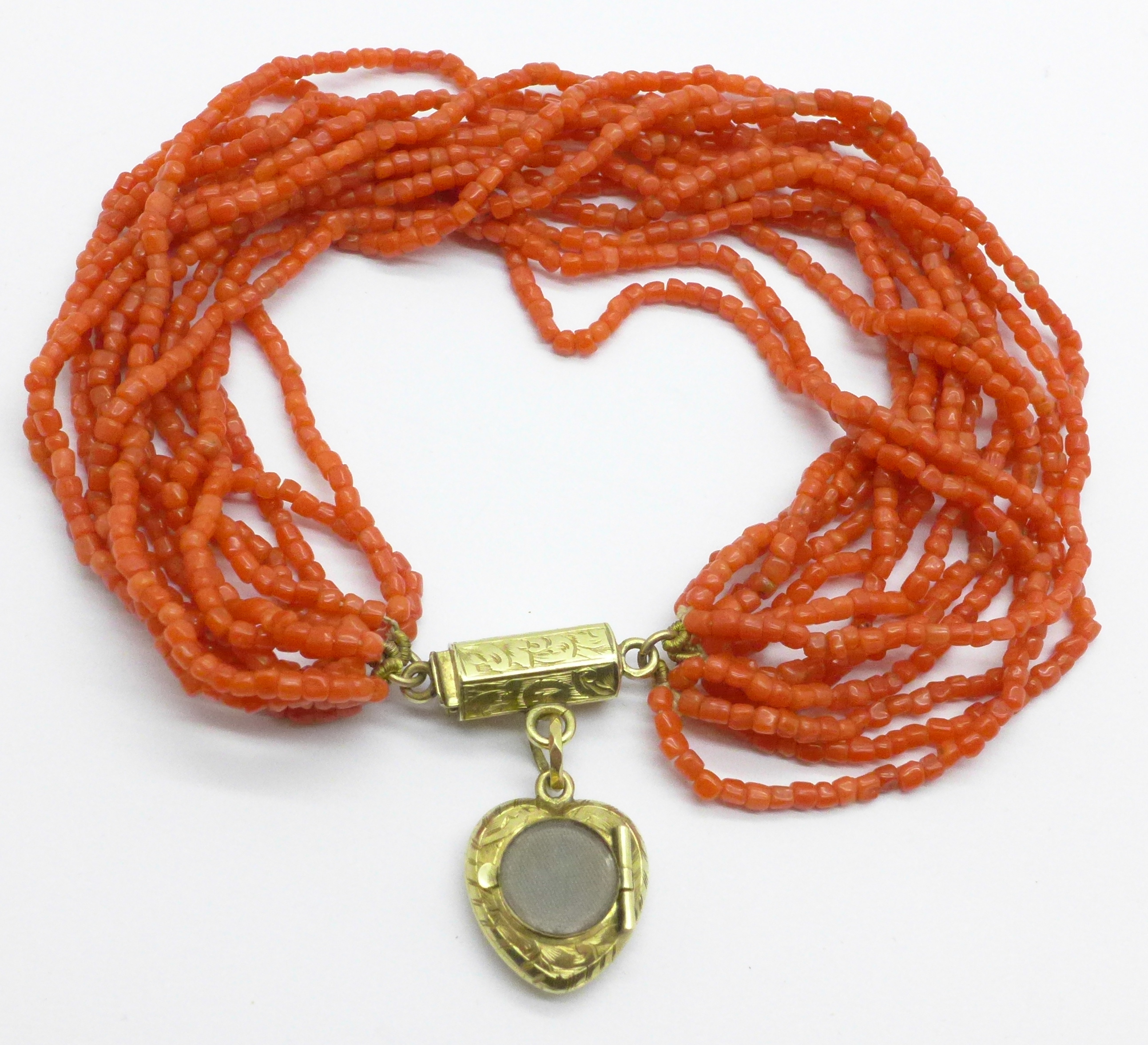 An early 20th Century coral bracelet with heart shaped memorial locket