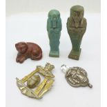 A scarab set pendant, lacking brooch pin, two small model sarcophagus, a carved cat and a deity