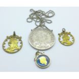 A Marie Theresia coin, in a silver mount, a silver mounted George VI coin and two cut out Queen