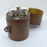 Three silver topped glass flasks in a fitted leather case, London 1924, leather strap/fastener a/f