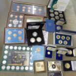 A collection of coins in frames, folders and cases