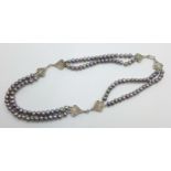 A hallmarked silver and coloured pearl necklace