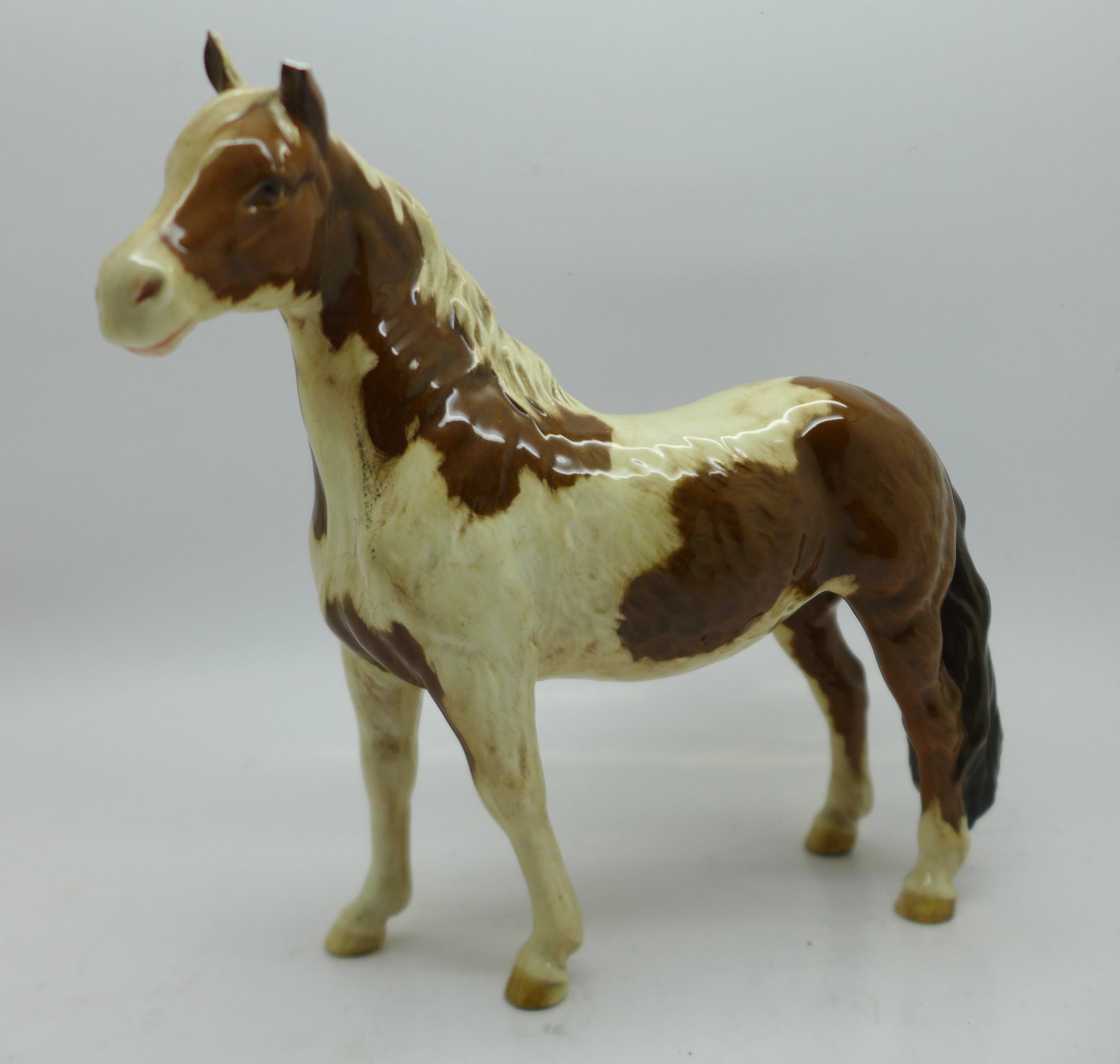 A Beswick Pinto Pony, left ear chipped