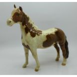 A Beswick Pinto Pony, left ear chipped