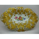 A Meissen hand painted oval pierced dish, floral decoration to the centre, vine leaves in gold