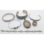 Three silver bangles and a silver bracelet, one other bangle, a ring and a white metal locket,