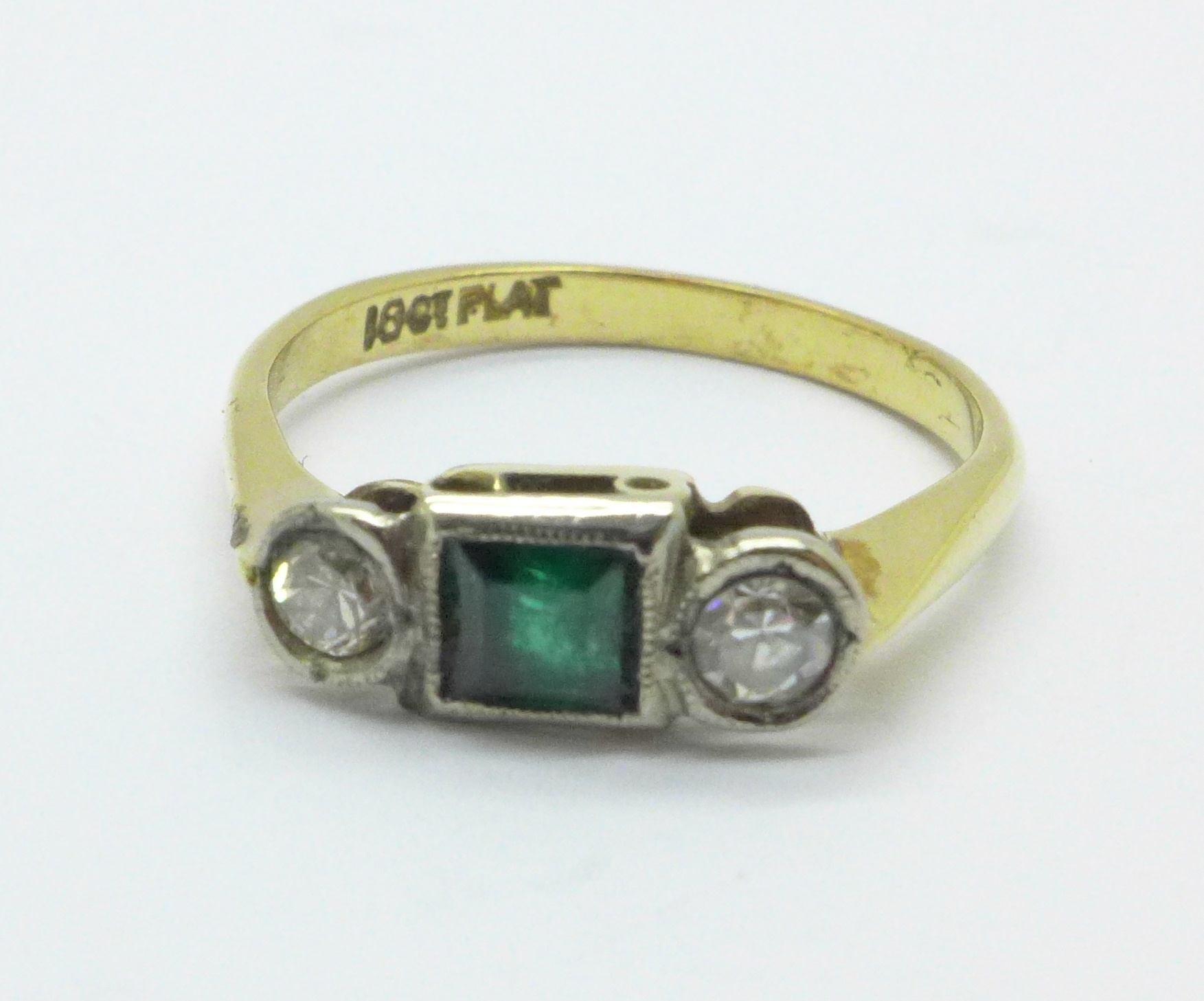 An 18ct gold, platinum set diamond and green stone ring, 2.7g, M