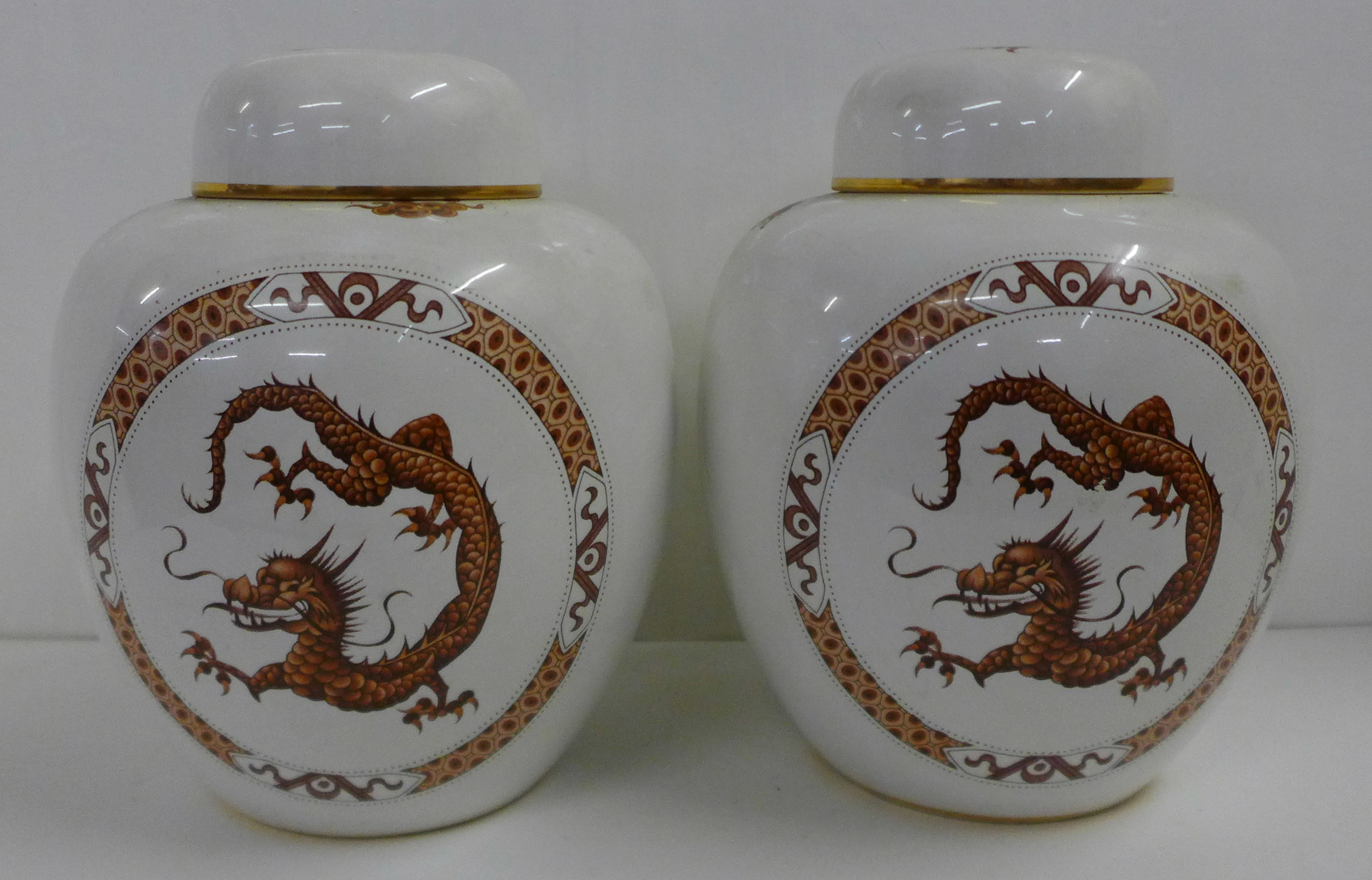 A pair of Carlton Ware ginger jars decorated with oriental dragons, 22cm