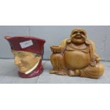 A Royal Doulton character jug and a carved wooden Buddah