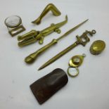 A collection of brass items including letter opener, pill box, compass/magnifying glass, etc.