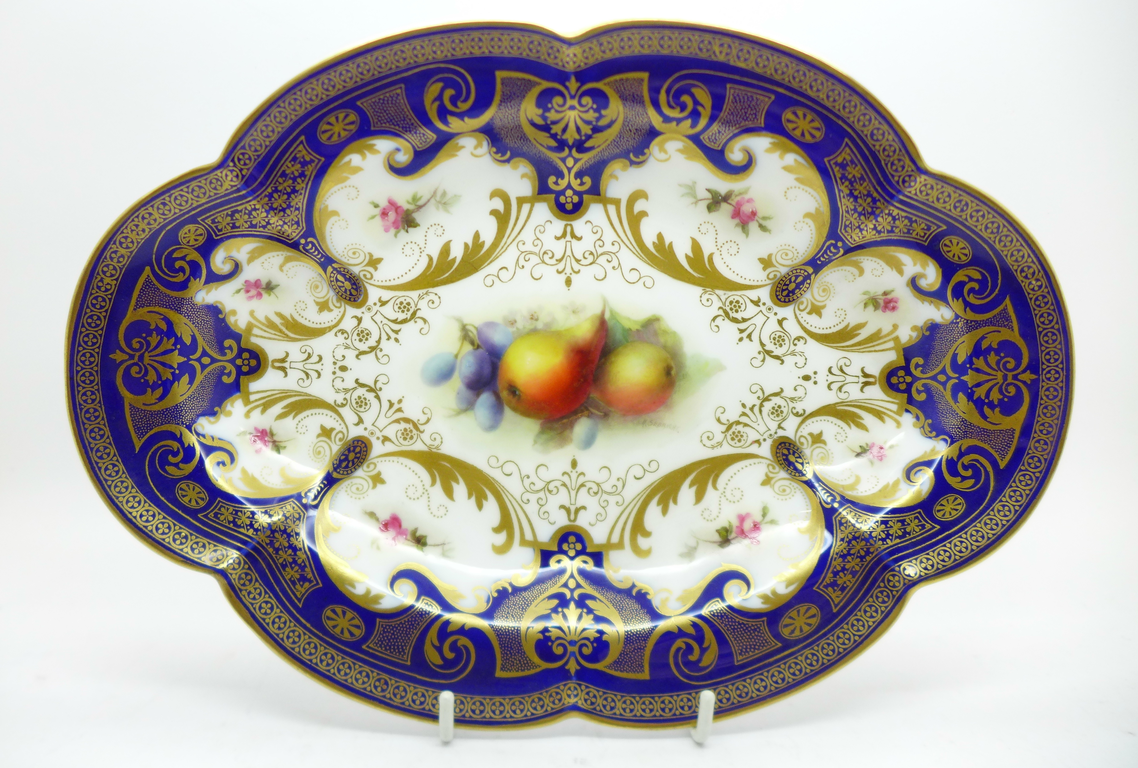 A Royal Worcester dish, hand decorated with fruit, signed Sebright, width 27cm