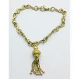 A 9ct gold bracelet with a yellow metal tassel fob, 11.4g