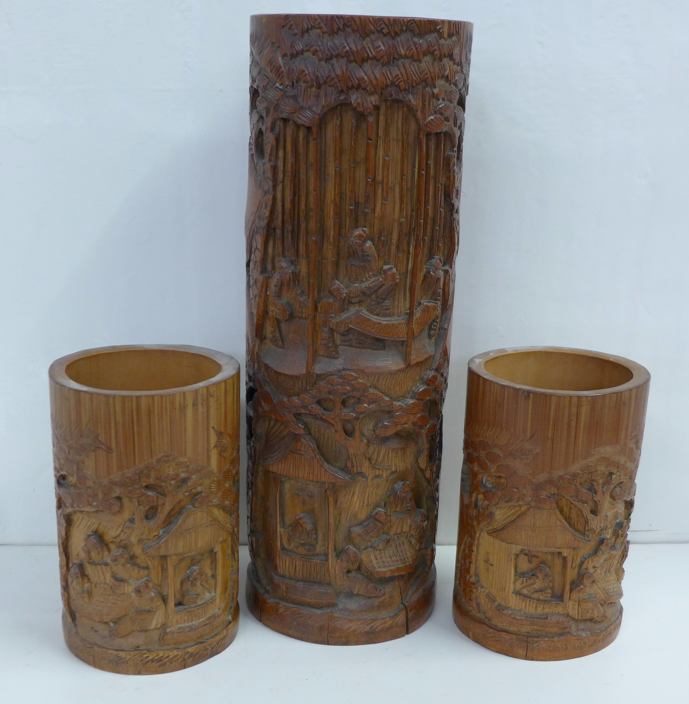 A tall carved bamboo brush pot, 33cm and a small pair of carved bamboo brush pots, 15cm