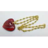 A Baccarat red glass heart shaped pendant, signed, 39mm wide