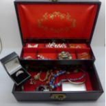 A jewellery box with agate set brooches, a rolled gold bangle, bead necklaces and a silver pendant
