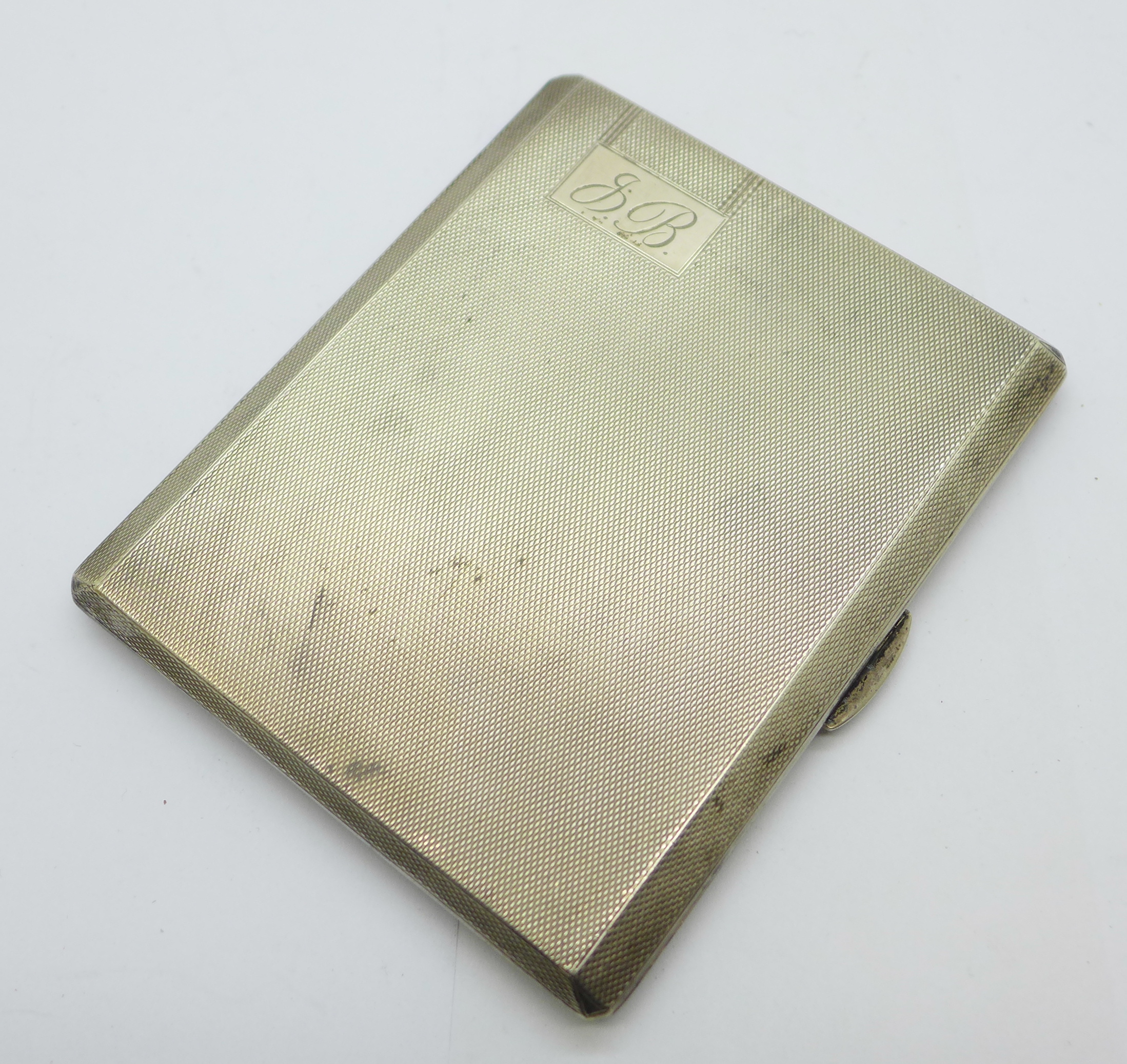 A silver cigarette case with machine turned finish, engraved initials to front, Walker & Hall, 139g