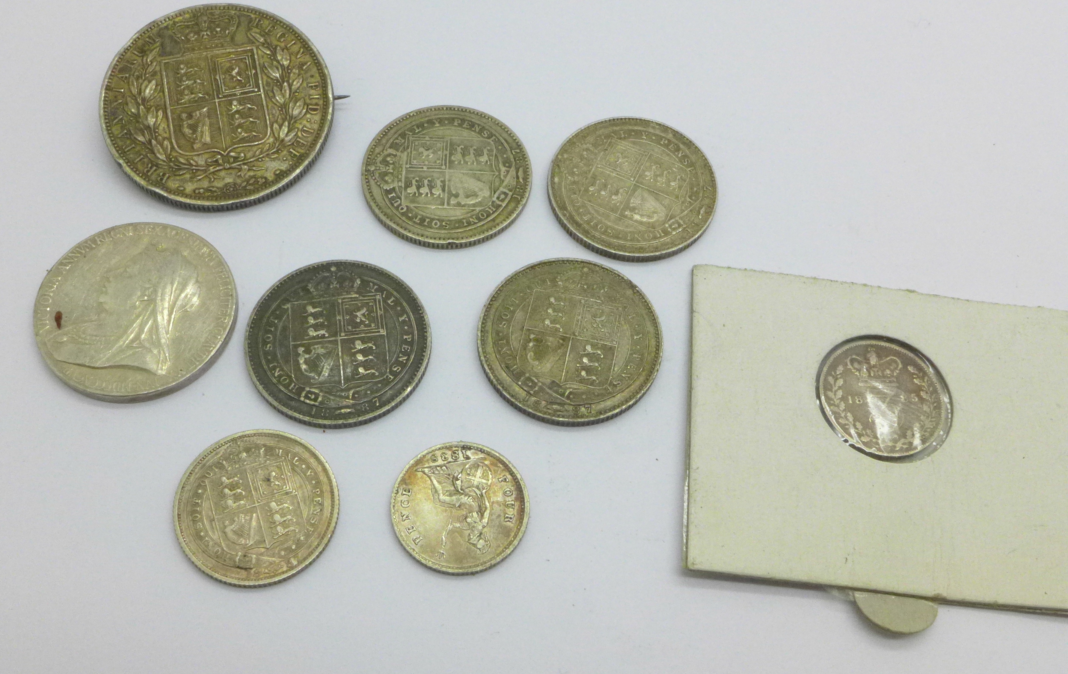 Nine Victorian silver coins, including an 1838 four pence and an 1838 half crown with mounted pin