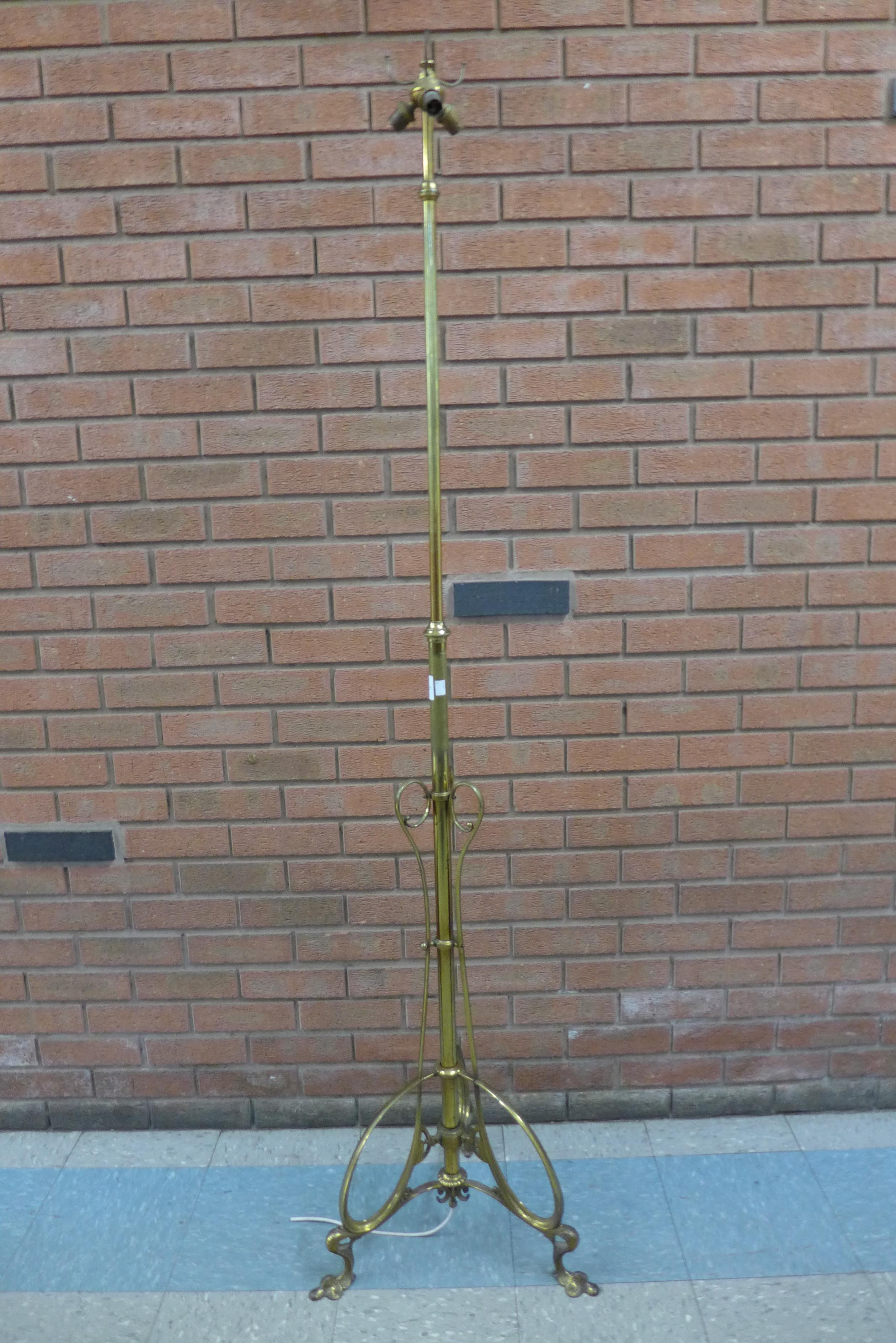 An Arts and Crafts brass telescopic floor standing down lighter, manner of W.A.S. Benson