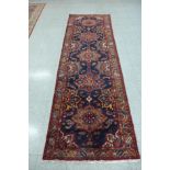 A north west Iranian red ground runner rug, 298 x 95cms