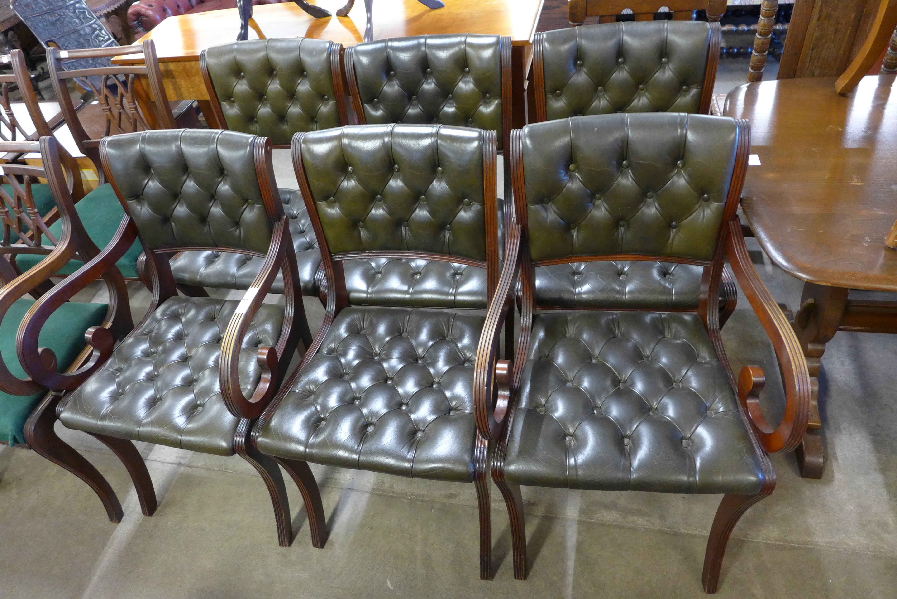 A set of six Beresford & Hicks Regency style mahogany and green leather chairs