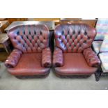 A pair of red button back leather armchairs