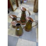 Four copper and brass jugs
