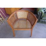 A hardwood bergere tub chair