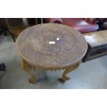 An Indian carved hardwood and brass inlaid occasional table