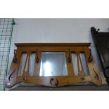 An Arts and Crafts carved oak hall mirror