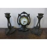 A French Art Nouveau bronzed clock garniture