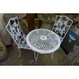 A painted cast alloy garden table and two chairs