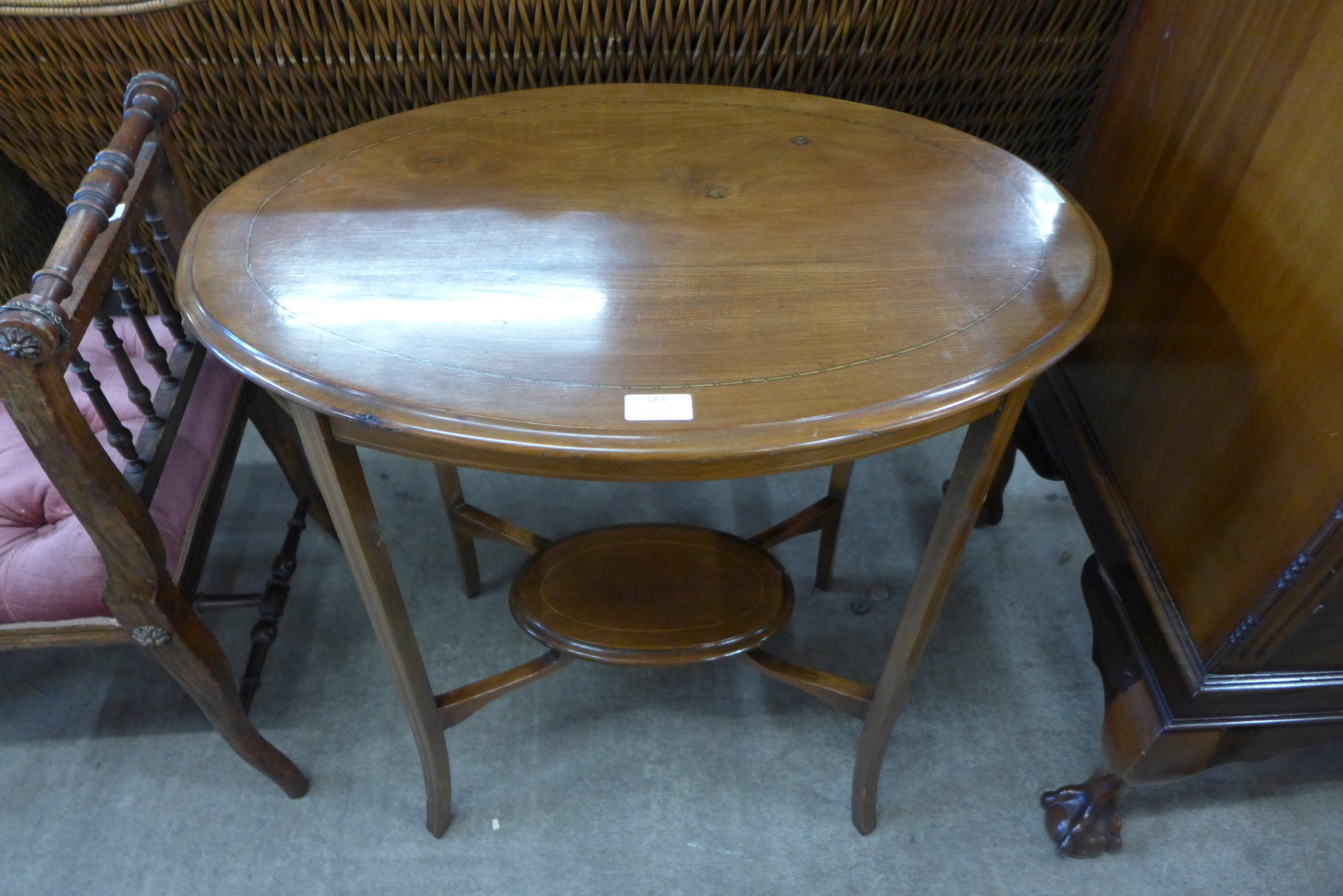 An Edward VII inlaid mahogany two tier oval occasional table