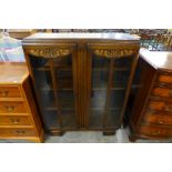 A carved oak two door bookcase